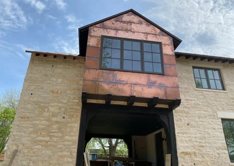 Copper metal panel facade on a stone building for Metal Roof Coating in Santaquin